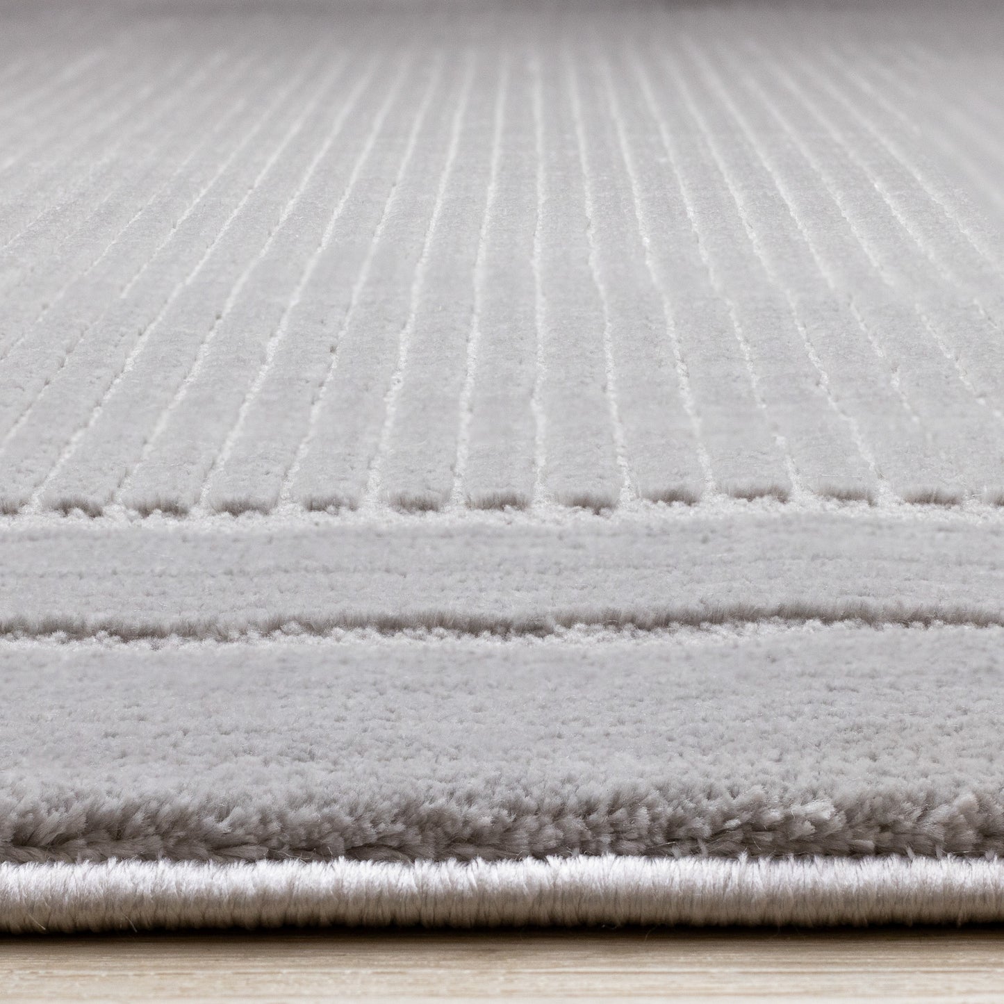 Alfombra contemporánea con borde gris