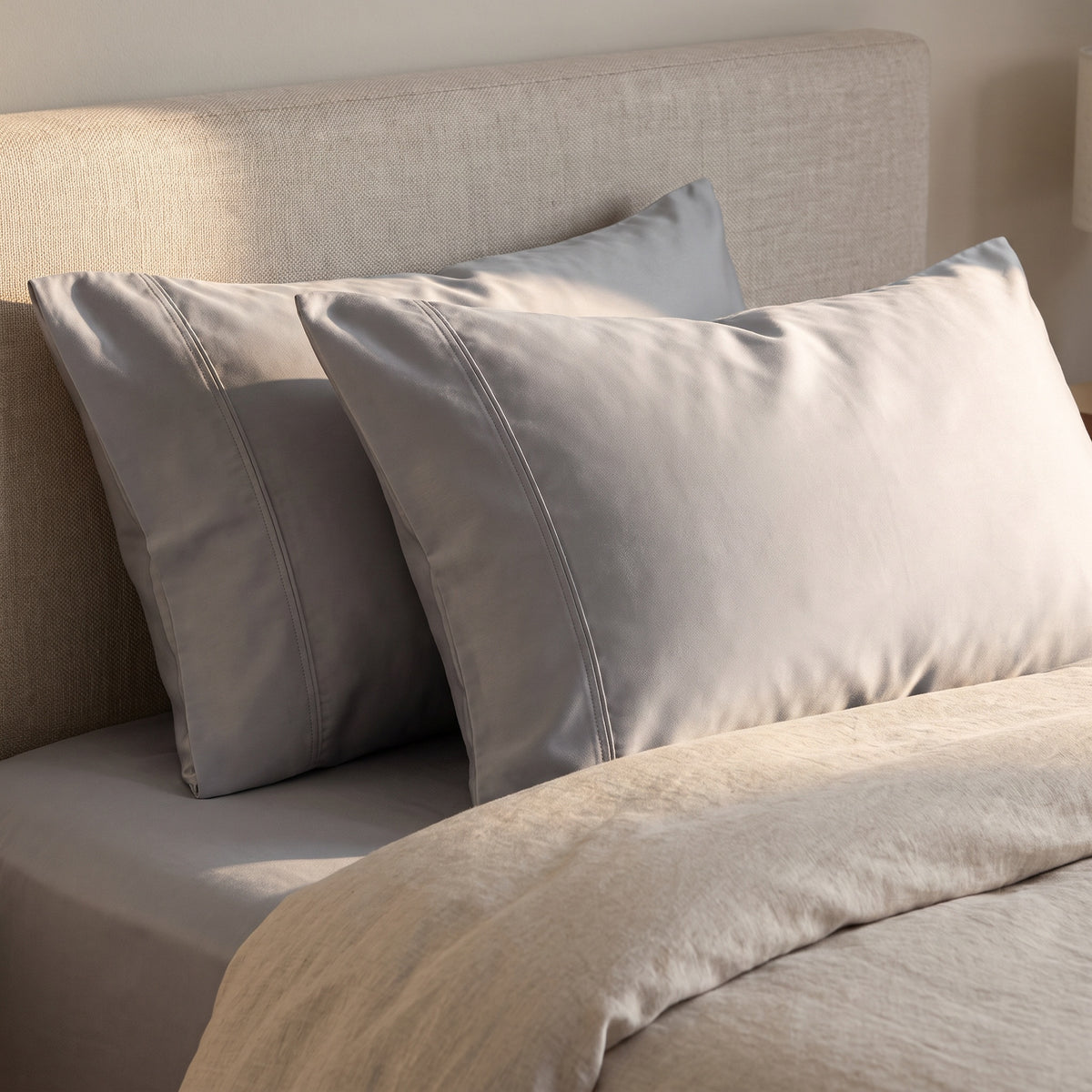 Calla Cotton Light Grey Pillowcases in a room