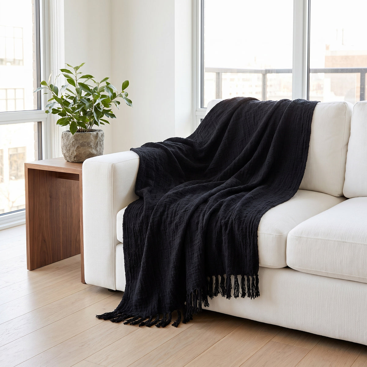 Sova Cotton Deep Black Throw in a room