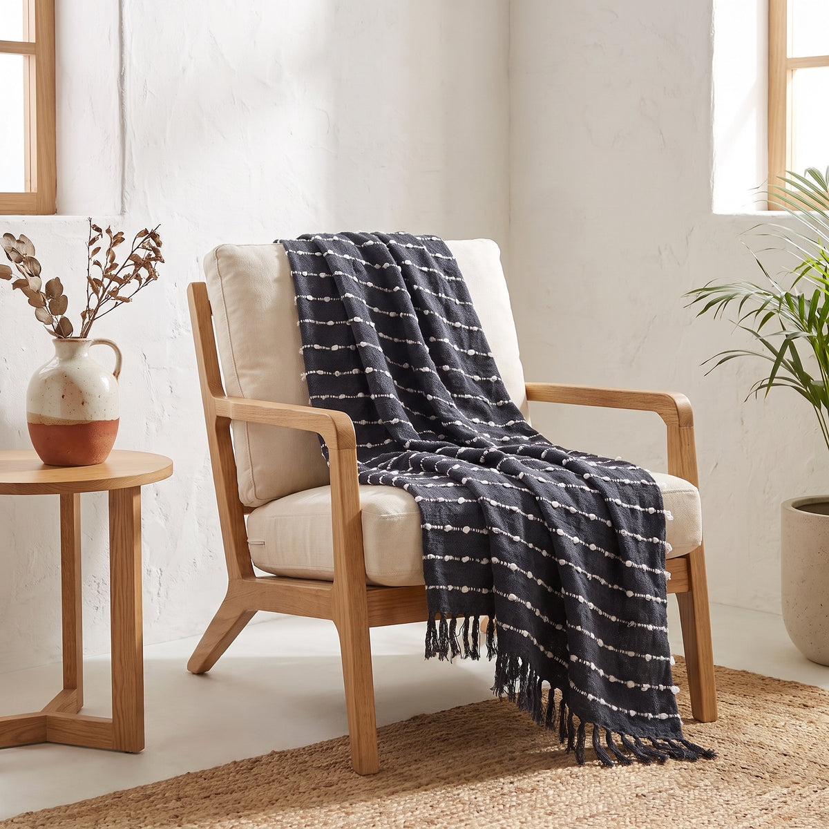 Sova Cotton Charcoal Throw in a room