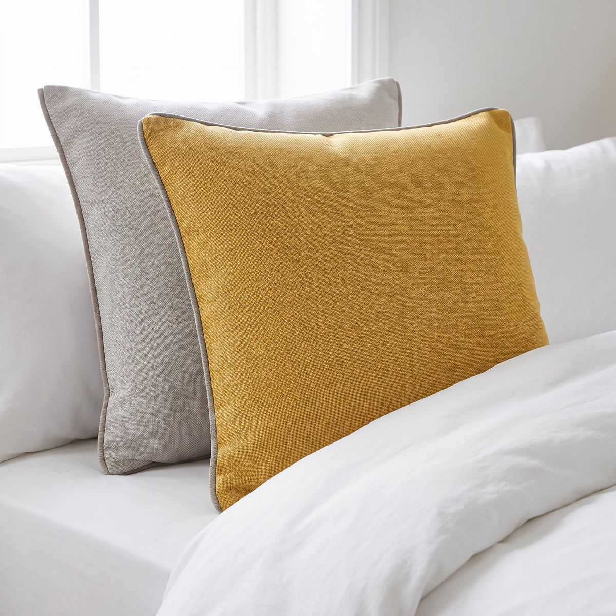 Tova Textured Yellow and Light Grey Pillow in a room