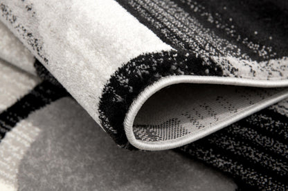 Alfombra negra con cuadros geométricos Montage